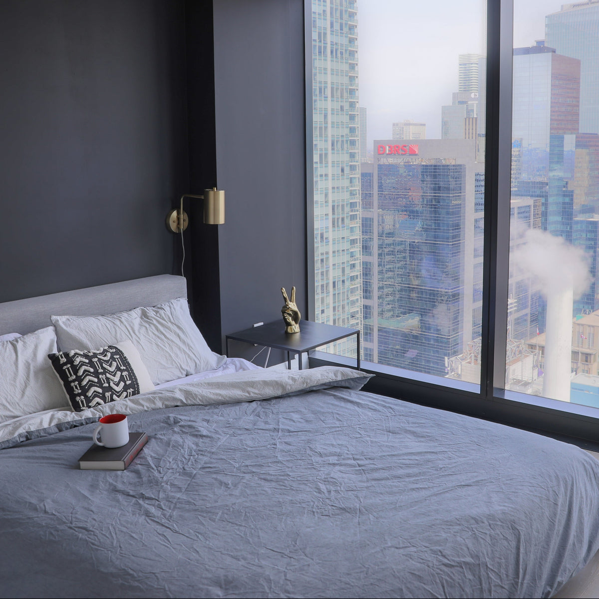 gray bedroom in urban highrise building