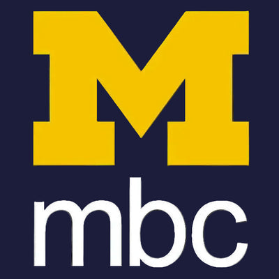 A digital graphic featuring a large yellow block letter 'M' above the white lowercase text 'mbc' on a dark navy blue background with a faint architectural silhouette.